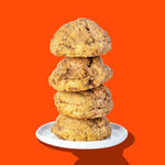 A stack of four Hunky Chunky Cinnamon Roll cookies rolled in cinnamon sugar