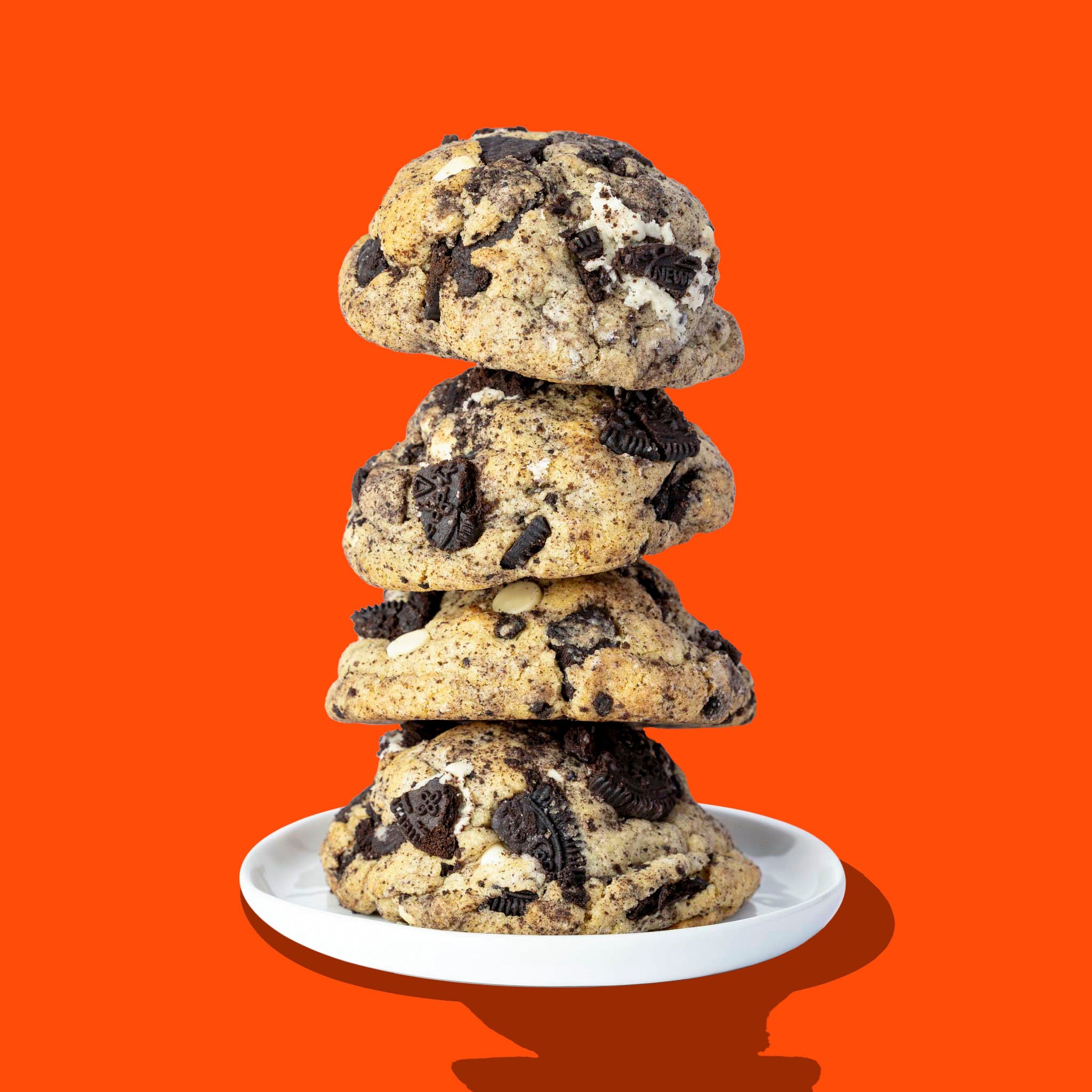 A stack of four Hunky Chunky Cookies and Cream cookies with crushed chocolate sandwich cookies