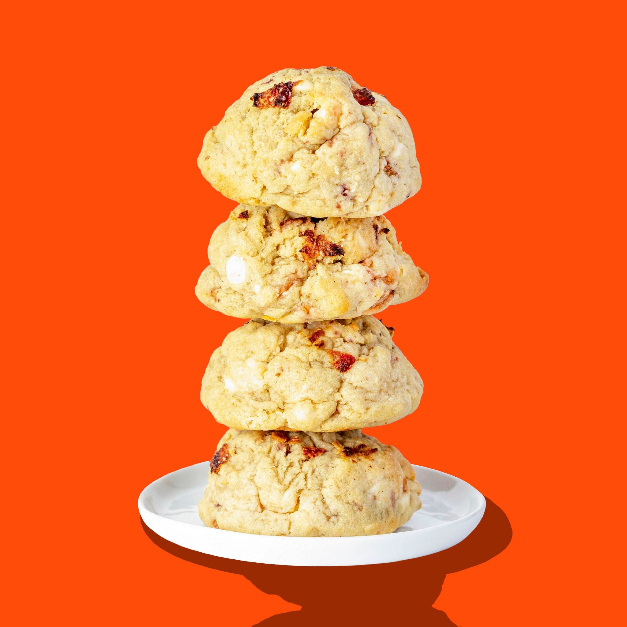 A stack of four Hunky Chunky Strawberry Shortie cookies with freeze-dried strawberries
